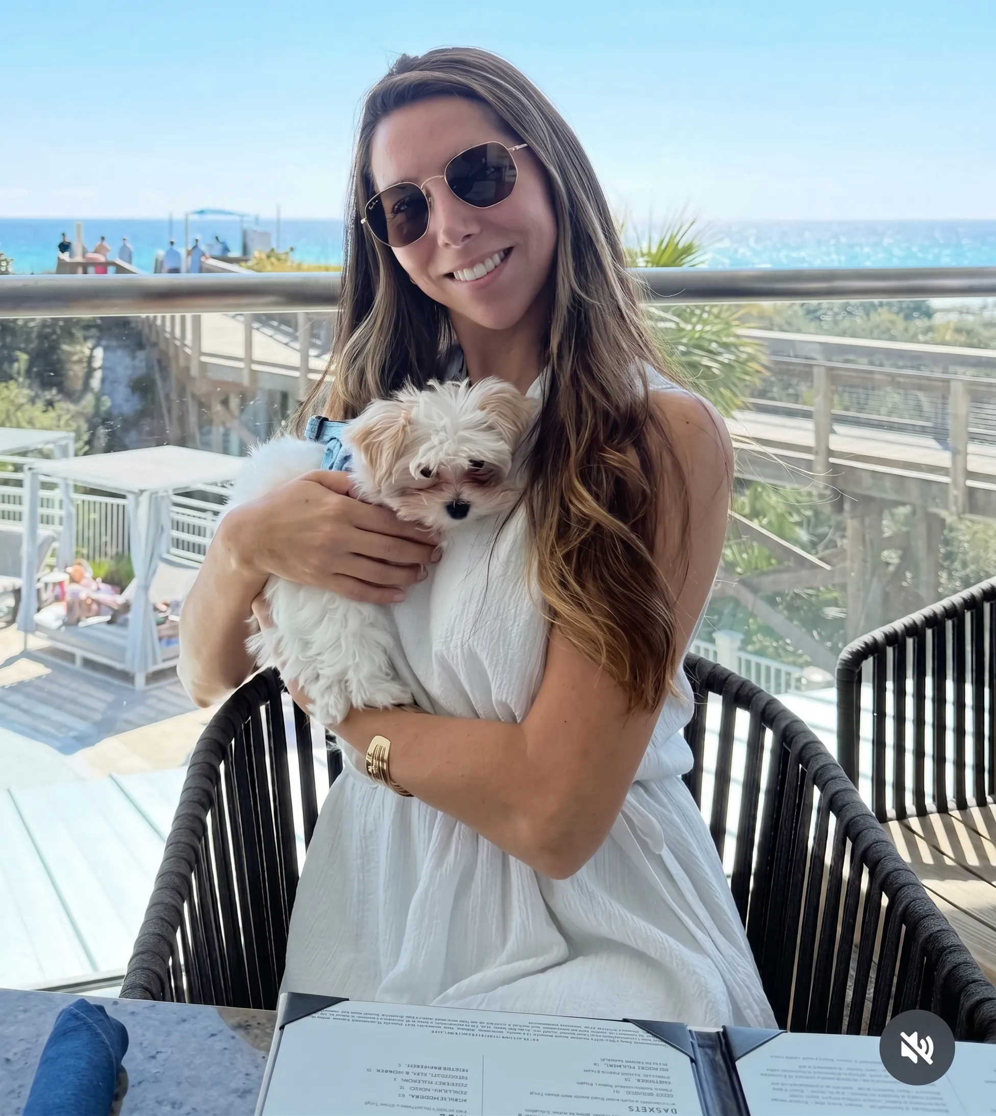 Karina Artau, Founder of The Coastal Dog Society, holding her dog Milo